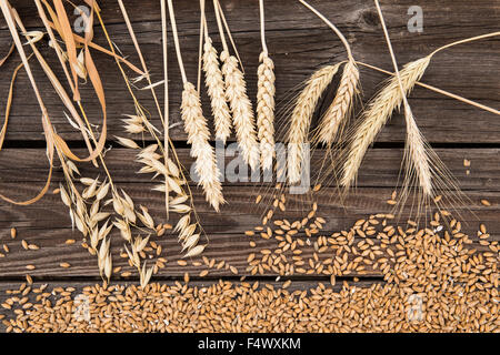 Ears of wheat on old wooden table Stock Photo