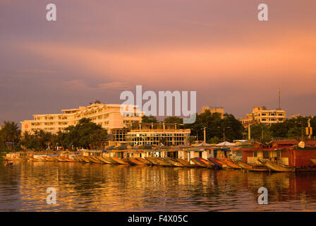 Dragon boat cuises at sunset on the river Huong (Perfume River). Vietnam. Dragon head and excursion boat, Song Huong or Huong Giang or Perfume River, near Hue, North Vietnam, Vietnam, Southeast Asia. Stock Photo