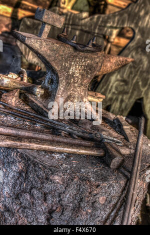 A rusty anvil and old tools found in an old barn in Alaska Stock Photo