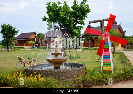 Decoration of gardening Pin wheel or windmill and fountain in garden at Phrae, Thailand Stock Photo