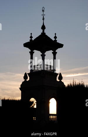 Sunset at The National Art Museum of Catalonia in Barcelona. Towers and statues appear in silhouette against the setting sun. Stock Photo