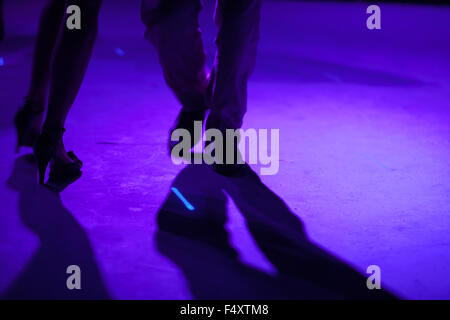 Detail of shoes with shadows in milonga ballroom. Stock Photo