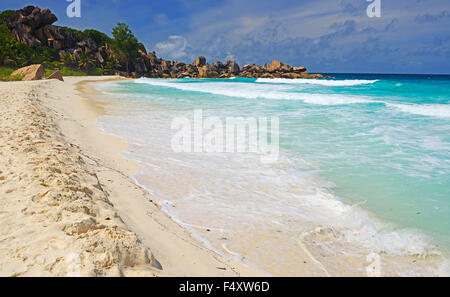 Grand Anse, dreamlike beach with rocks and palm trees, La Digue Island, Seychelles Stock Photo