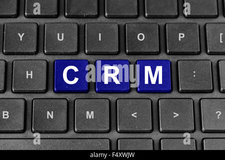 CRM or Customer relationship management blue word on keyboard Stock Photo