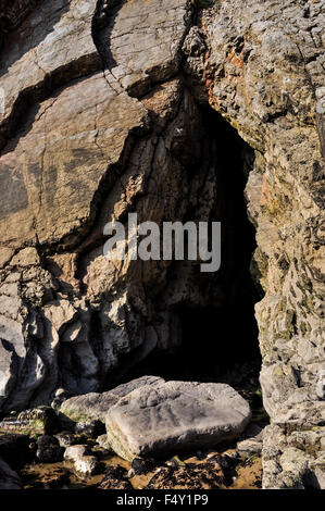Cave entrance on the beach at Bullslaughter bay in Pembrokeshire, Wales. Stock Photo