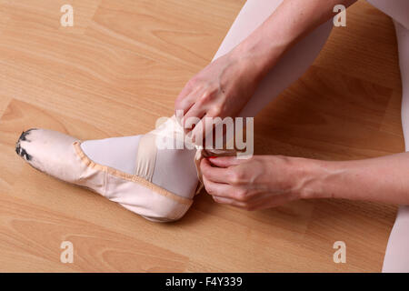 July 2015 - Young ballerina dressing and warming up. Stock Photo