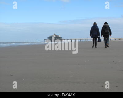 Blankenberge, Belgium. 22nd Oct, 2015. Two people walk along the beach of Blankenberge, Belgium, 22 October 2015. The Belgium North Sea beach is clean again after a ship accident left it covered with oil. Two weeks ago a freighter hit a gas tanker. Photo: Laura Lewandowski/dpa/Alamy Live News Stock Photo