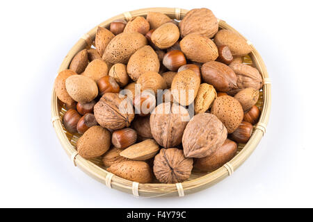 Mix nuts in wicker basket on white background Stock Photo