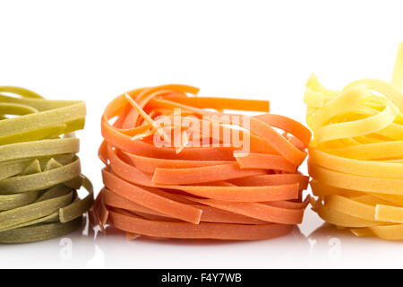 three colour roll nest pasta on a white background Stock Photo