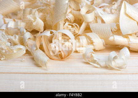 shavings spiral out of hand jointer scattered on pine boards Stock Photo