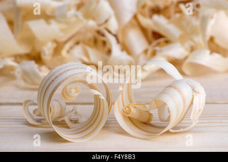 shavings spiral out of hand jointer scattered on pine boards Stock Photo