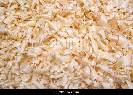 shavings spiral out of hand jointer scattered on pine boards Stock Photo