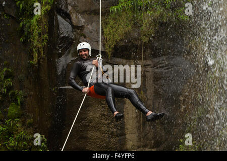 Adult Man Descending An Ecuadorian Waterfall In A Correct Position Stock Photo