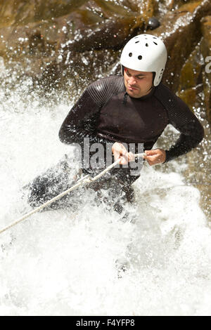 Adult Man Descending An Ecuadorian Waterfall In A Correct Position Stock Photo