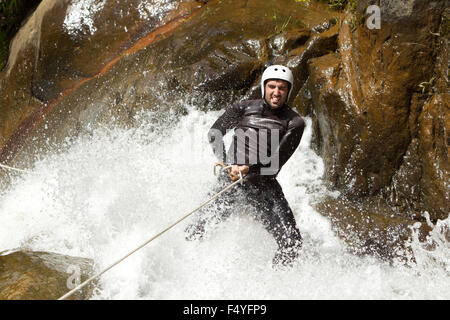 Adult Man Descending An Ecuadorian Waterfall In A Correct Position Stock Photo