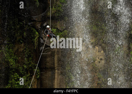 Adult Man Descending An Ecuadorian Waterfall In A Correct Position Stock Photo