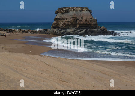 Rock formation standing high on the beach at Porto Novo Portugal Stock Photo