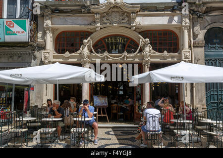 Customers sitting at the tables outside the Majestic Cafe on the Rua Santa Caterina Porto Portugal Stock Photo