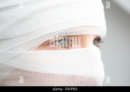 closeup of woman wrapped in bandages with beautiful eyes Stock Photo