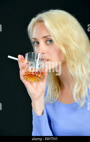 Blond woman drinking and smoking Stock Photo