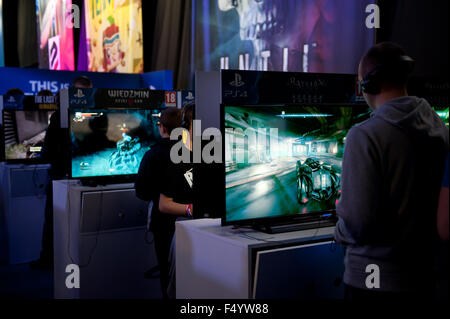 Warsaw, Poland. 24th Oct, 2015. Trade fair show consoles stand at games expo, people playing in Batman and Wiedzmin at Warsaw Games Week, Targi Gier Wideo, Hala Expo XXI, Warsaw, Poland, October 24, 2015, horizontal orientation, rights managed, editorial use only. Credit:  Arletta Cwalina/Alamy Live News Stock Photo