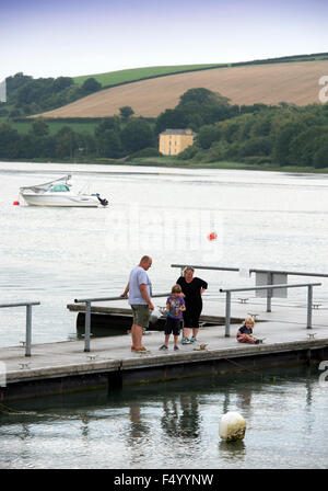 A family crabbing off a jetty at St Dogmaels, Pembrokeshire, Wales UK Stock Photo