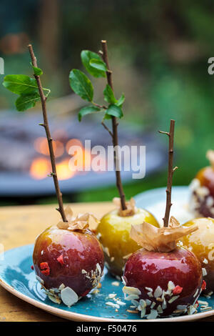 Toffee apples and a bonfire in the background Stock Photo