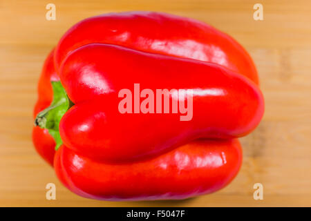 Red bell pepper on wooden table Stock Photo