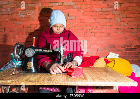 Female tailor at work on the street Stock Photo