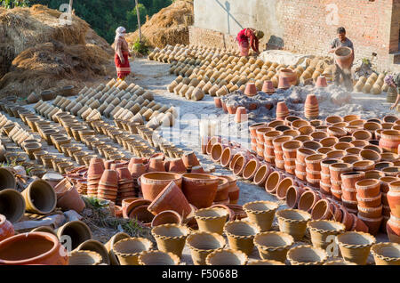 Workers sorting out pottery after the burning process Stock Photo