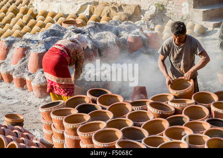 Workers sorting out pottery after the burning process Stock Photo