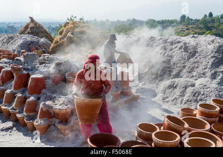 Workers sorting out pottery after the burning process Stock Photo