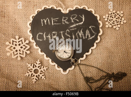 Retro Christmas and New year concept on canvas with snowflakes and watch from above (retro sepia toning) Stock Photo