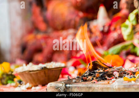 Flame burning in front of a Ganesha shrine Stock Photo