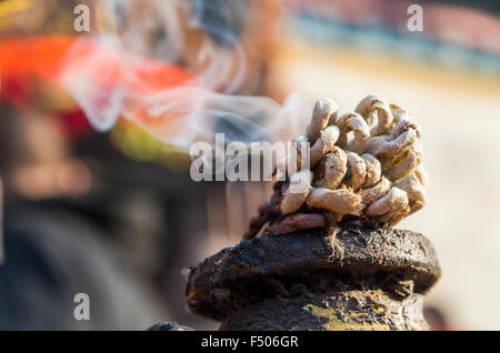 Flame burning in front of a Ganesha shrine Stock Photo