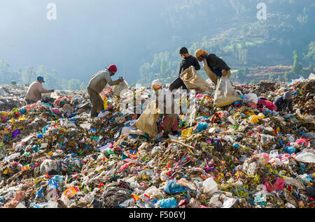 Workers sorting out garbage at Aletar garbage dump, earning 300-400 nepali rupees a day Stock Photo