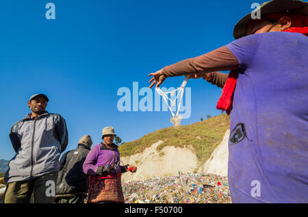 Woman sorting out garbage at Aletar garbage dump, found a piece of cheap jewellery Stock Photo