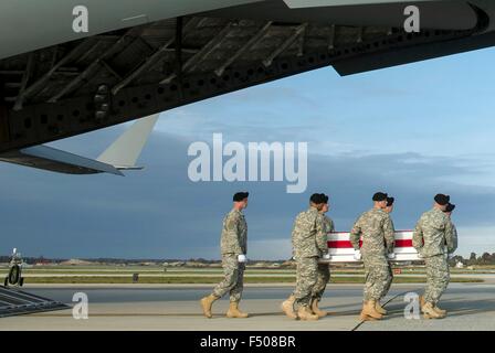 A US Army carry team transfers the remains of U.S. Army Master Sgt. Joshua L. Wheeler killed in action in Iraq during a removal ceremony October 24, 2015 at Dover Air Force Base, Delaware. Secretary of Defense Ash Carter attended the ceremony to pay his respects to the fallen soldier. Stock Photo