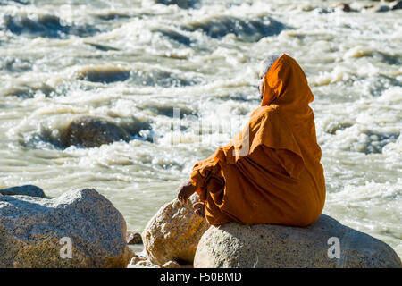 A Sadhu, holy man, is sitting and meditating in lotus pose, padmasana ...