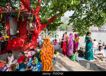 A holy tree is painted red near Harki Pauri Ghat at the holy river Ganges Stock Photo