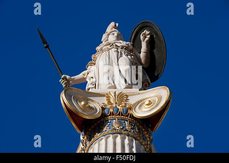 Closeup of the Greek goddess Athena / Pallas Athene statue, and ornament pillar elements against blue sky. Athens, GR Stock Photo