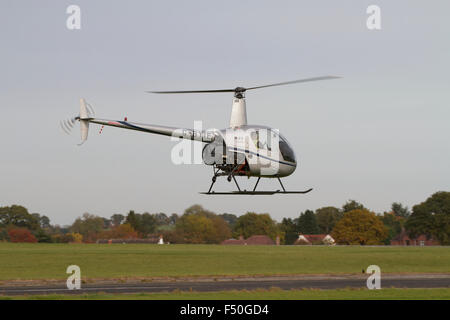 Small helicopter hovering. Wolverhampton Halfpenny Green Airport. UK Stock Photo