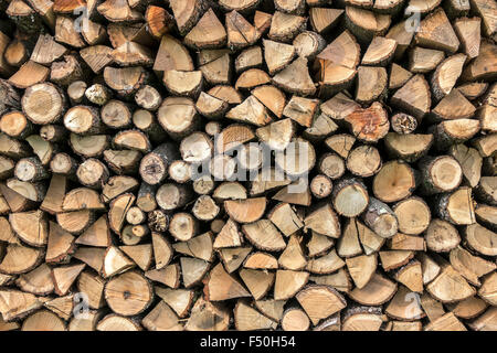 Background of dry chopped firewood logs in a pile, close up Stock Photo