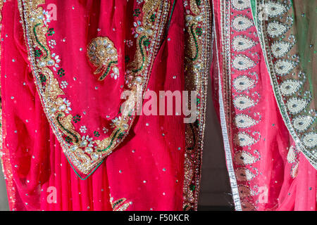 Colorful material is for sale in a shop in a small street of the old walled Pink City Stock Photo