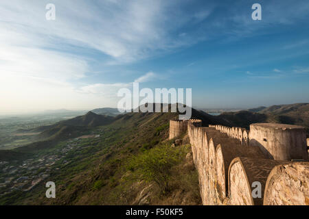 Landscape around Amber Fort with part of an old wall, blue sky and hills in the distance Stock Photo