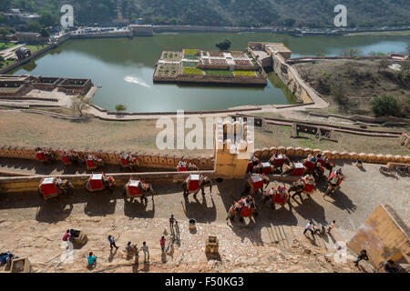 The Maota lake and gardens seen from Amber Fort, tourists on elephants are taking a ride up to the palaces Stock Photo
