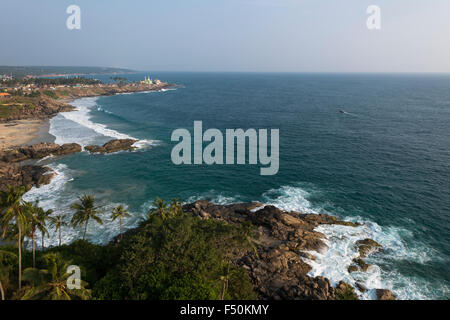 Rocky coastline north of Kovalam Beach with palmtrees and blue water Stock Photo