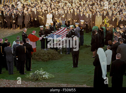 Arlington, Virginia, USA  25th November 1963. An honor guard folds the flag of the United States at Arlington National Cemetery in preparation for flag presentation to Jacqueline Kennedy. At the end of the burial services 'Jackie' lit an eternal flame to burn continuously over his grave. At 3:34pm EST the casket containing his remains was lowered into the Wilbert 'Triune' grave vault. 'Out of mortal sight but not out of hearts and mind' Credit: National Archives via Mark Reinstein Stock Photo