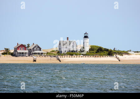 Sandy Neck Beach's old cottage colony and Sandy Neck Lighthouse seen from the water. Cape Cod, Massachusetts Stock Photo