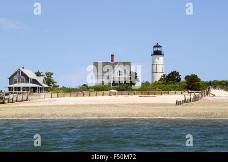 Sandy Neck Beach's cottage colony and lighthouse seen from the water, Cape Cod, Massachusetts Stock Photo